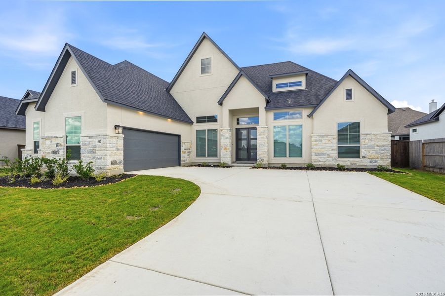 Front exterior of a new home in Mesa Western, Cibolo, TX, highlighting curb appeal (Image 26). Front exterior of a new home in Mesa Western, Cibolo, TX, highlighting curb appeal (Image 26).