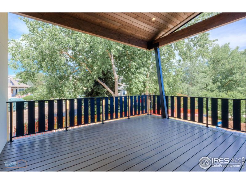 Main Floor Covered Deck Features A Custom Metal Railing.