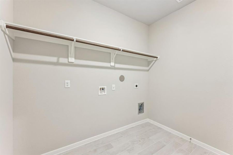 Step into this spacious laundry room with a washer and dryer connection.