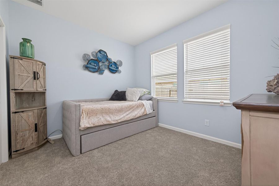 Comfortable bedroom featuring ample natural light and a clean layout
