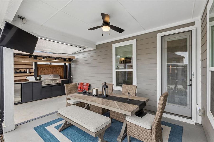 Host family dinners or casual gatherings in the covered outdoor dining area, conveniently located adjacent to the outdoor kitchen for seamless entertaining.