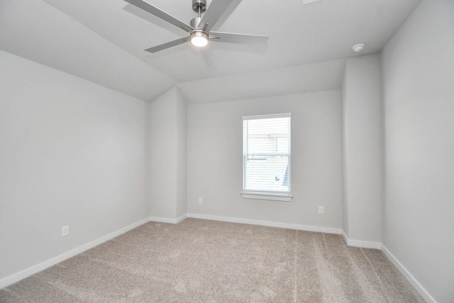 Secondary bedroom features plush carpeting, large windows that let in plenty of natural light, bright paint, and spacious closets. Sample photo of completed home with similar floor plan. Actual colors and selections may vary. Secondary bedroom features plush carpeting, large windows that let in plenty of natural light, bright paint, and spacious closets. Sample photo of completed home with similar floor plan. Actual colors and selections may vary.