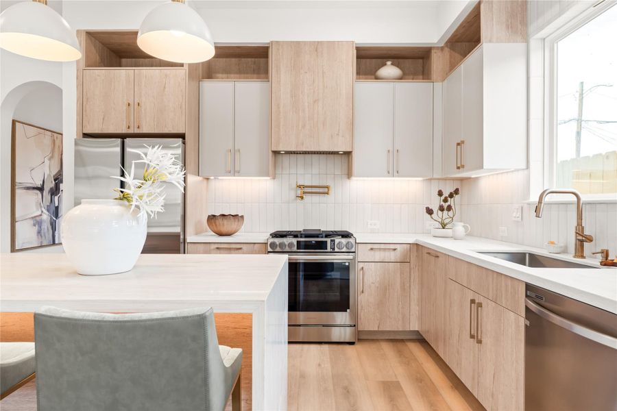 A dedicated pot filler above the range and a full tile backsplash make this cooking wall as practical as it is polished. Every inch here is designed to make cooking easier, not harder.