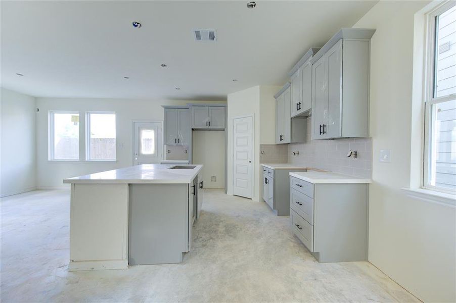 Color coordinated cabinets and backsplash