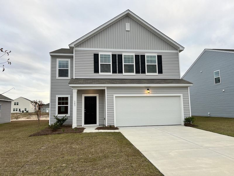 Front exterior of a new home in Pender Woods at Cane Bay, Summerville, SC, highlighting curb appeal (Image 1). Front exterior of a new home in Pender Woods at Cane Bay, Summerville, SC, highlighting curb appeal (Image 1).