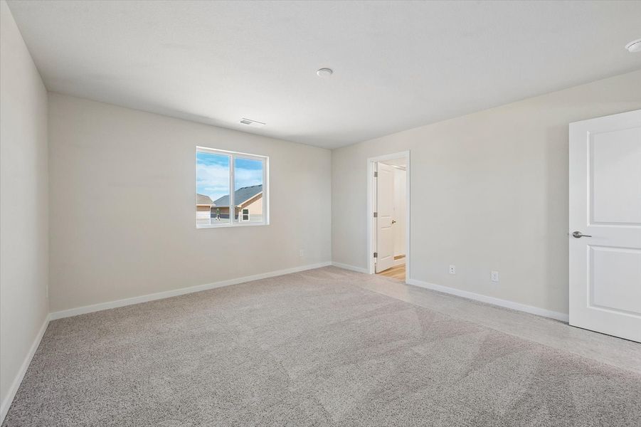 A room with a window and a carpet.