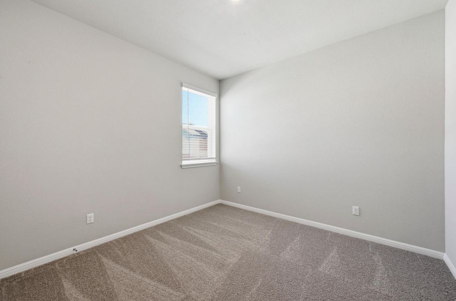 Carpeted room with a single window featuring horizontal blinds Carpeted room with a single window featuring horizontal blinds