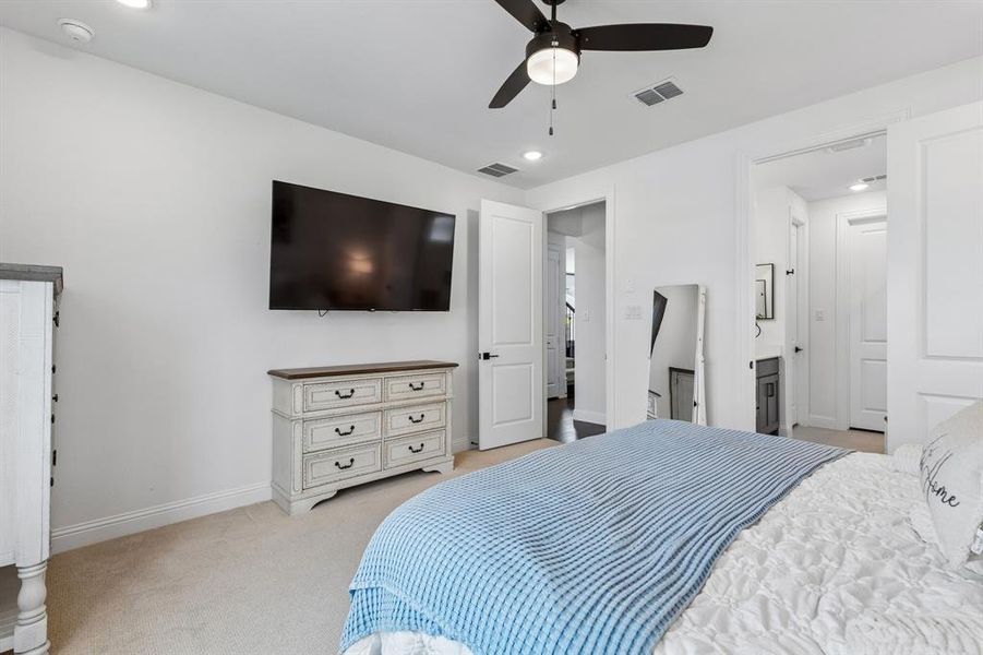 Large windows frame water views beyond the neighborhood, creating a peaceful backdrop that enhances the retreat-like atmosphere.