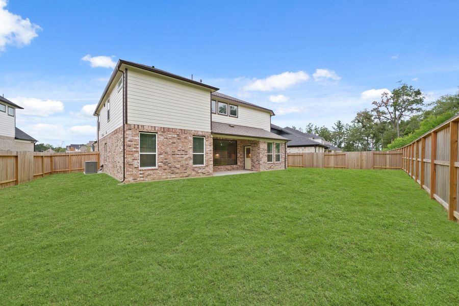 Front exterior of a new home in Barton Creek Ranch, Conroe, TX, highlighting curb appeal (Image 2). Front exterior of a new home in Barton Creek Ranch, Conroe, TX, highlighting curb appeal (Image 2).