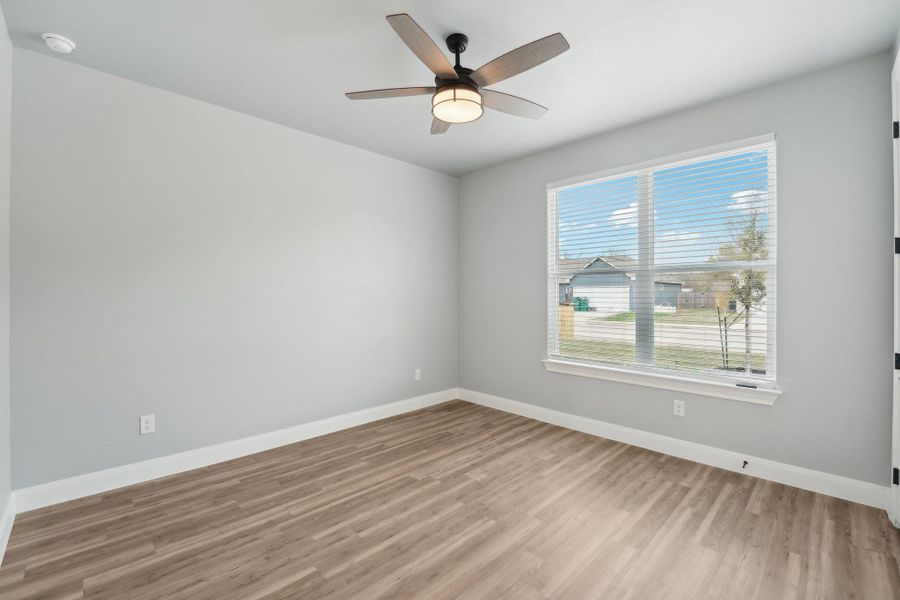 Bedroom 3 room featuring light wood finished floors, ceiling fan, and baseboards