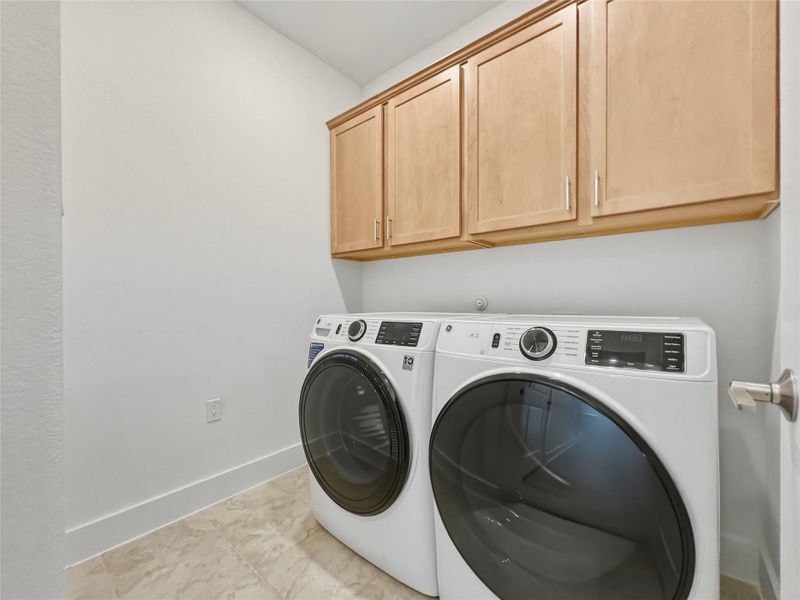 Laundry area featuring washer and dryer and cabinet space