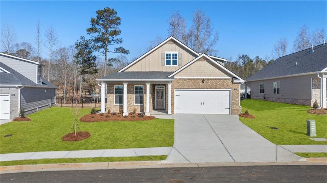 Front exterior of a new home in Oak Ridge Meadows - Active Adult, Locust Grove, GA, highlighting curb appeal (Image 1). Front exterior of a new home in Oak Ridge Meadows - Active Adult, Locust Grove, GA, highlighting curb appeal (Image 1).