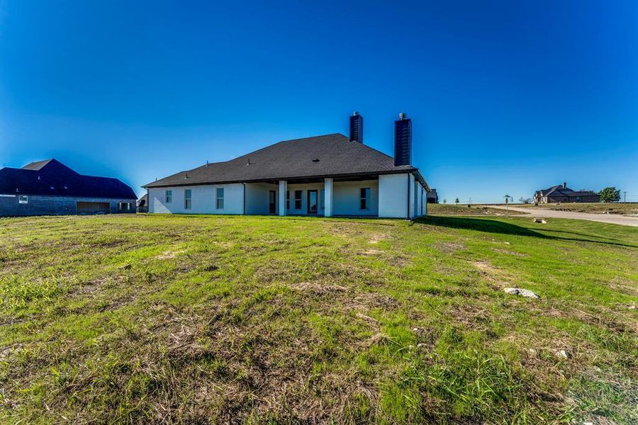 Rear view of house with a yard