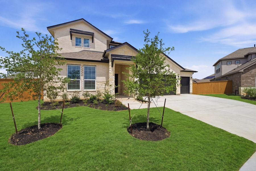 Front exterior of a new home in Sunterra, Katy, TX, highlighting curb appeal (Image 2). Front exterior of a new home in Sunterra, Katy, TX, highlighting curb appeal (Image 2).