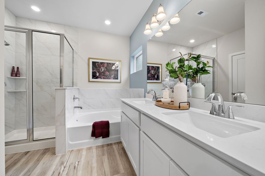 A bathroom with a tub sink and a shower.