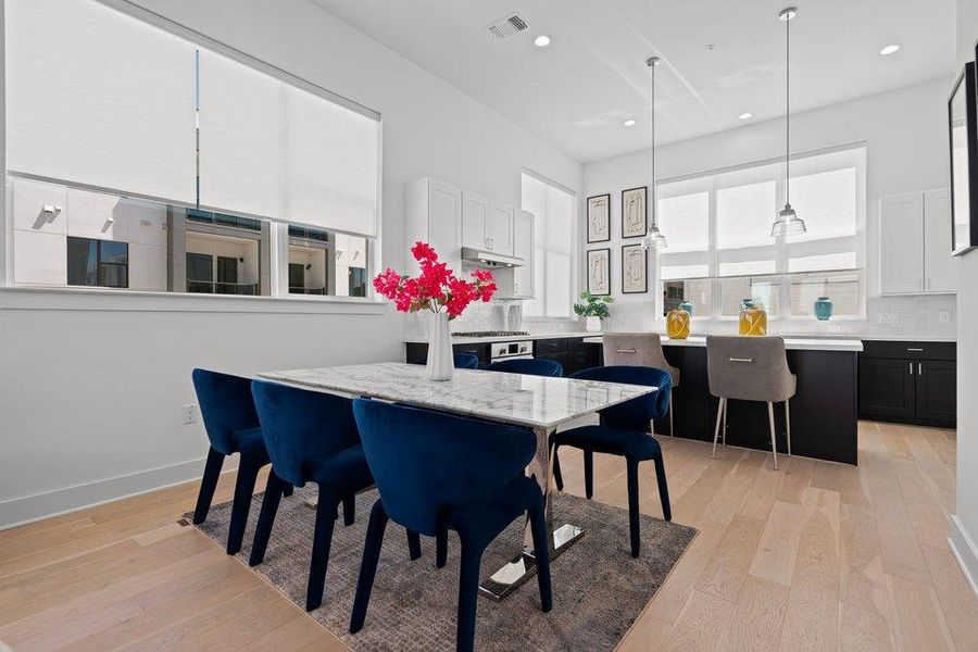 Clean lines and a functional layout define this bright kitchen and dining area. Clean lines and a functional layout define this bright kitchen and dining area.