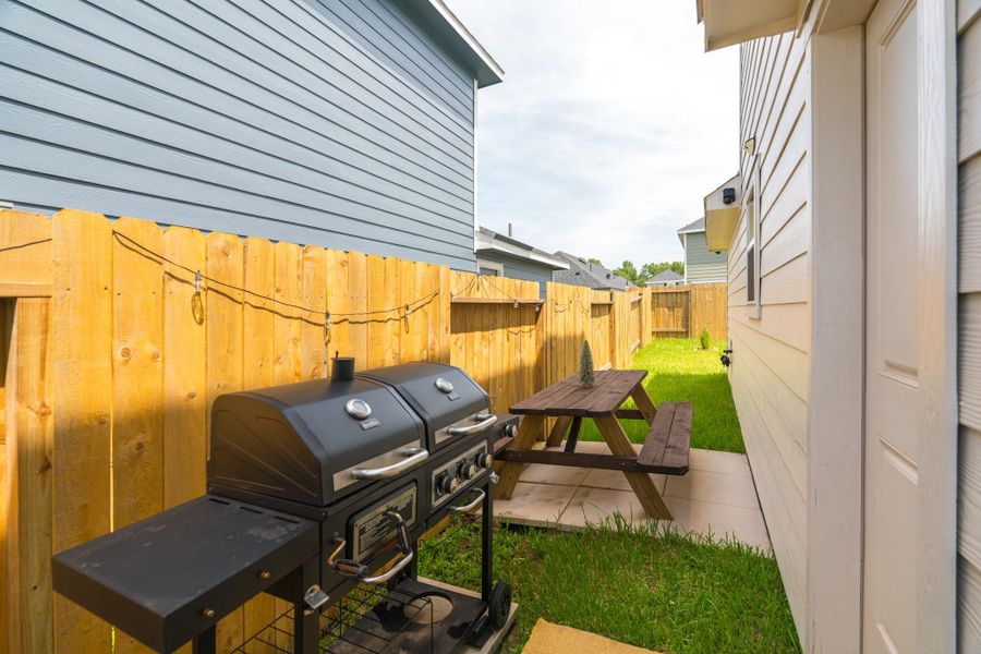 Rear patio area ideal for grilling, lounging, or weekend gatherings Rear patio area ideal for grilling, lounging, or weekend gatherings