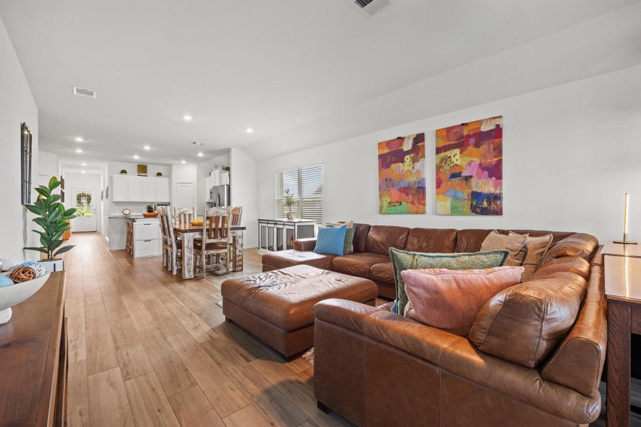 Open-concept living space flows seamlessly from the living area to the dining space and kitchen. Open-concept living space flows seamlessly from the living area to the dining space and kitchen.