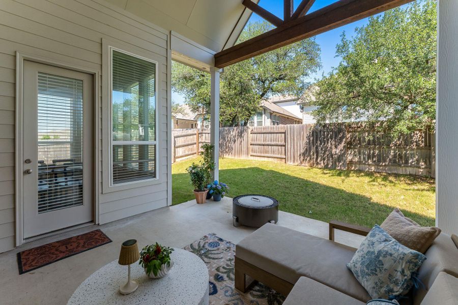 Covered patio featuring an exposed beam ceiling, concrete flooring, a full-lite door with integrated blinds, and siding exterior