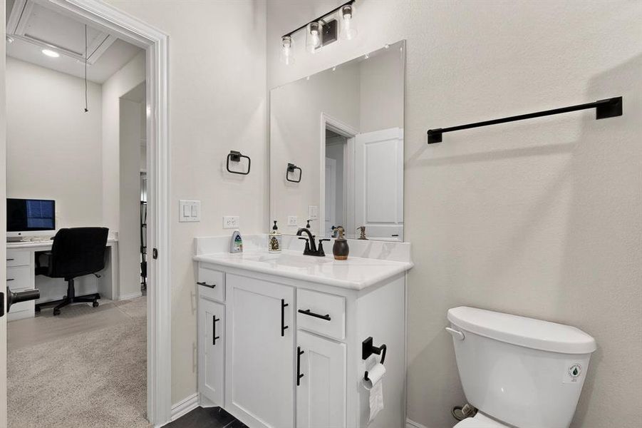 Bathroom featuring vanity and dark carpet Bathroom featuring vanity and dark carpet