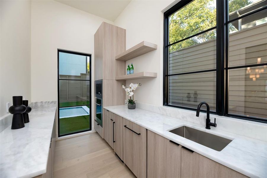 Prep Kitchen featuring light brown cabinetry and microwave and wine fridge