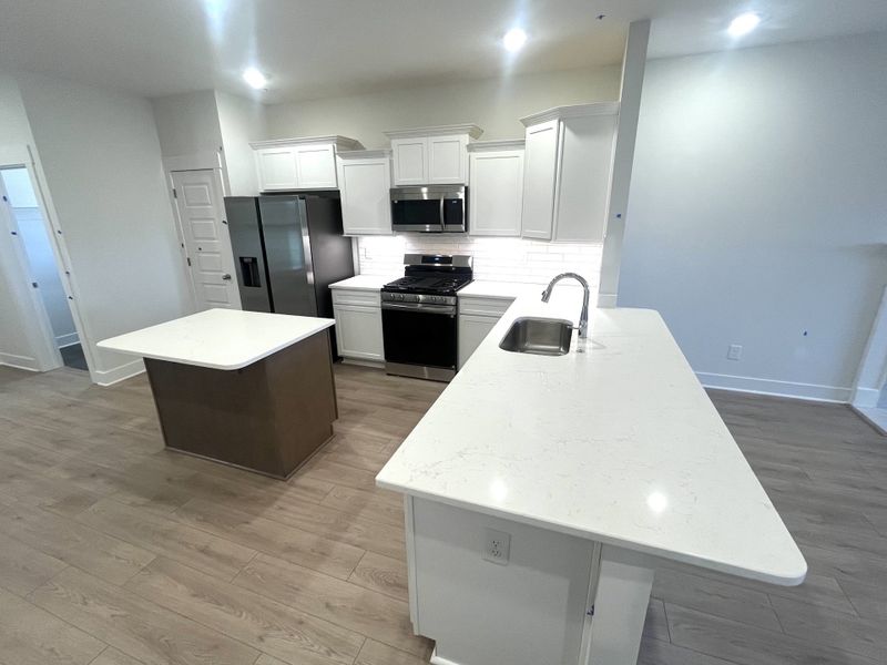 Lots of quartz surfaces to cook and entertain on. Nice comfy flow