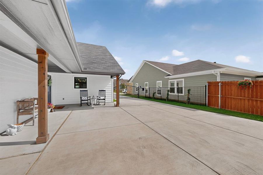 Patio area off the home with so much room to entertain or for additional parking inside the gate