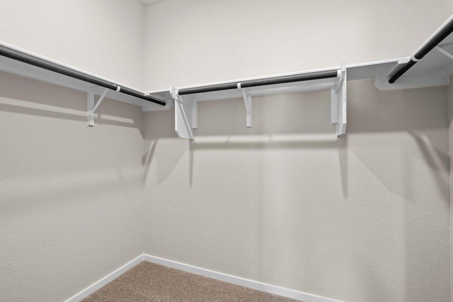 Walk-in closet in Primary Bedroom Walk-in closet in Primary Bedroom