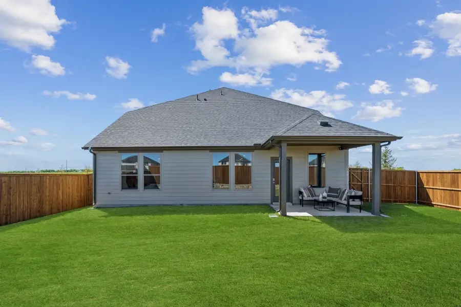 Covered Patio in a Sunset Ranch Winters Model Home in Gunter TX by Trophy Signature Homes