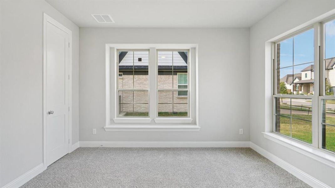 Spare room with light colored carpet and baseboards Spare room with light colored carpet and baseboards