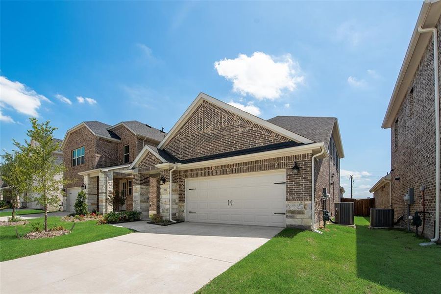 Front exterior of a new home in Walden Pond, Forney, TX, highlighting curb appeal (Image 1).