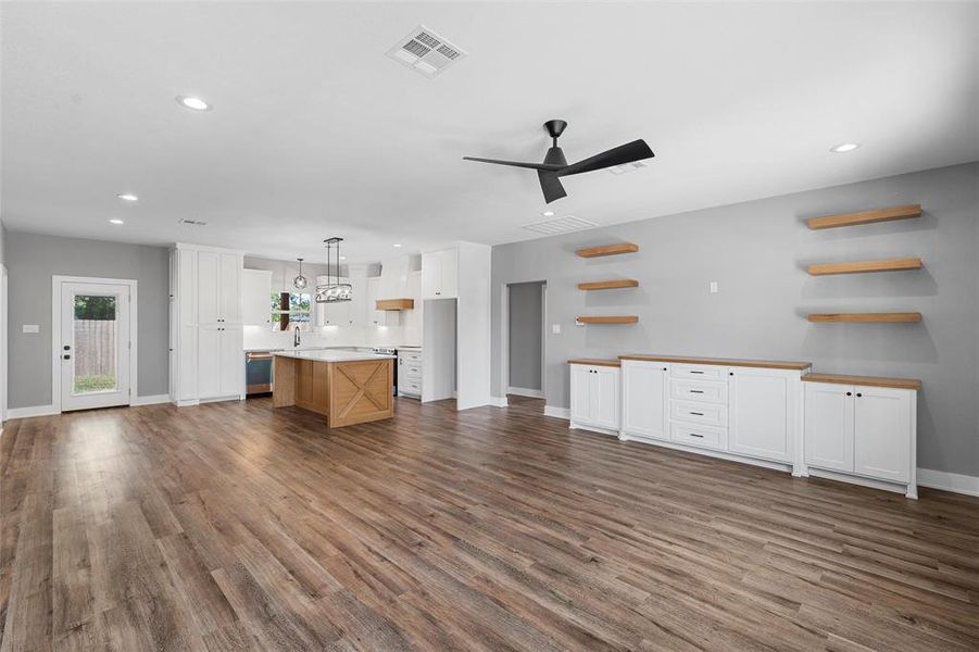 Unfurnished living room featuring recessed lighting, dark wood-style flooring, and ceiling fan