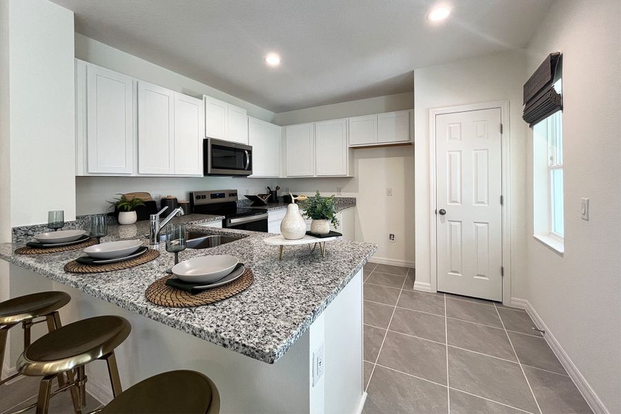 Ashley townhome model in Pine Meadows, Eustis FL — elegant two-story home with 4 bedrooms, 3 baths, and 1,898 sq. ft. of living space. Featuring an open-concept kitchen, dining, and living area, this modern townhome offers flexible layouts for families, guests, or a home office. Highlights include a spacious primary suite with private bath, second-floor laundry, covered lanai, and welcoming entry porch. Built with energy efficiency and stylish design, the Ashley townhome blends comfort, functionality, and charm in a sought-after Central Florida community.