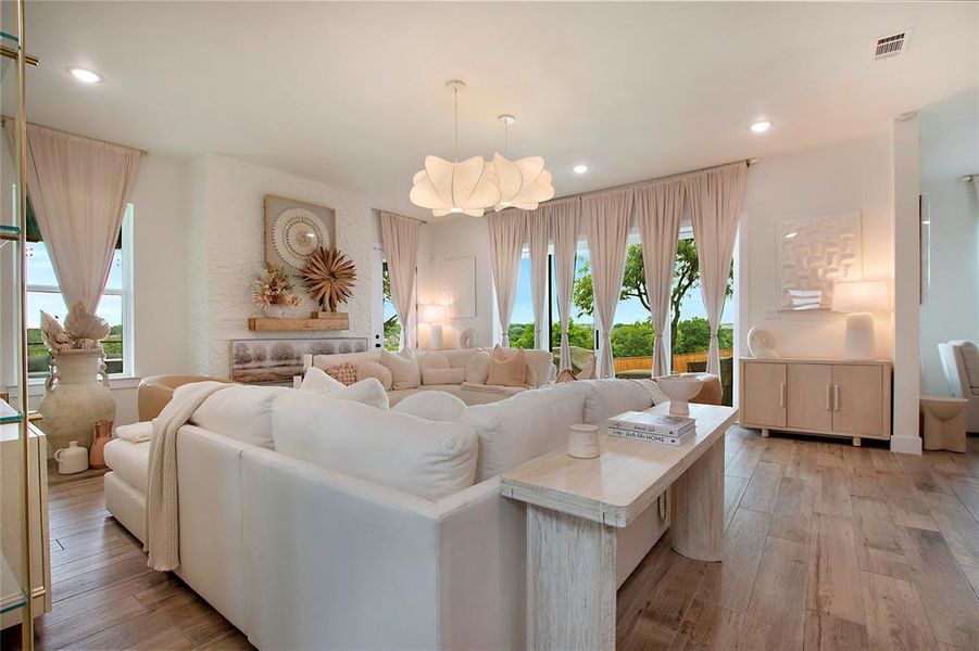 Living room with recessed lighting and light wood finished floors Living room with recessed lighting and light wood finished floors