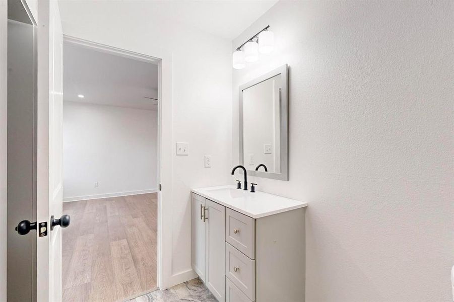 Bathroom featuring hardwood / wood-style flooring and vanity