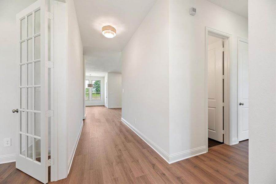 Hall with hardwood / wood-style floors