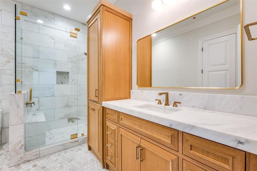 Bathroom featuring vanity and an enclosed shower