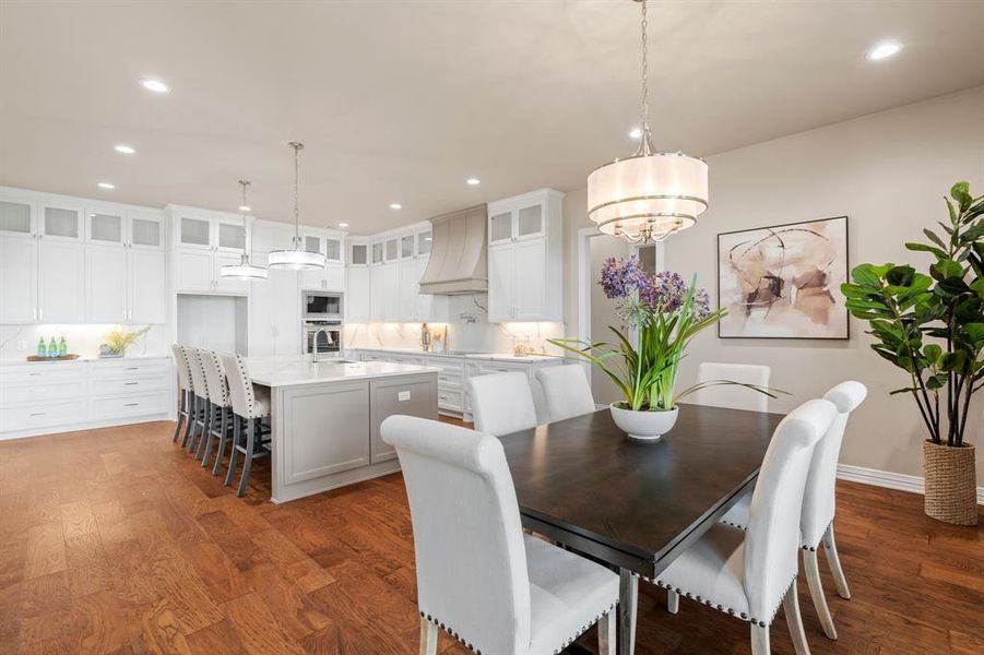 Dining space with a chandelier and dark hardwood / wood-style flooring