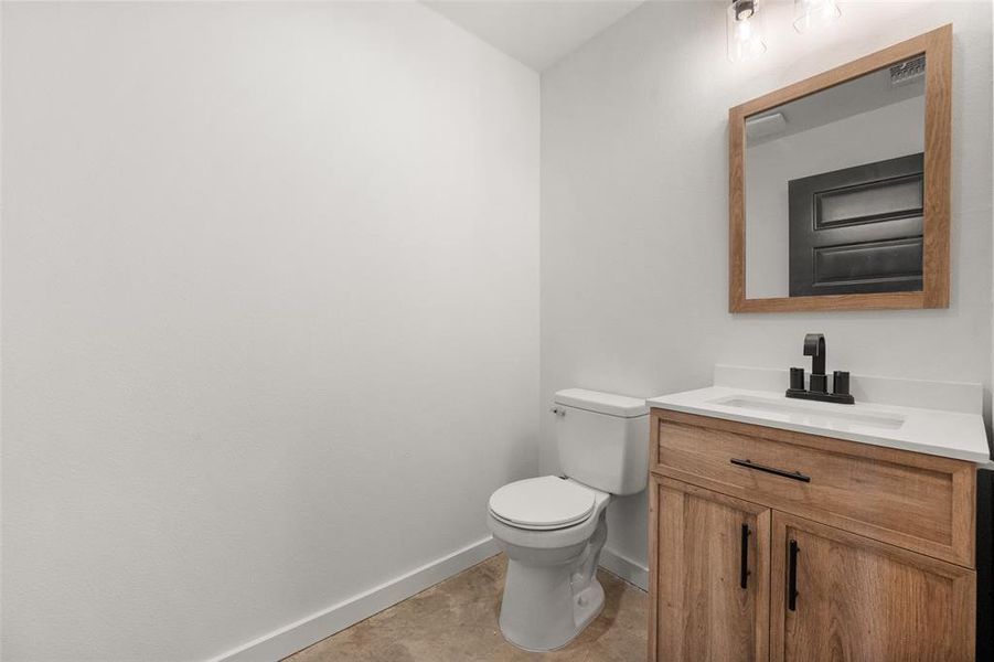 Bathroom featuring vanity and toilet