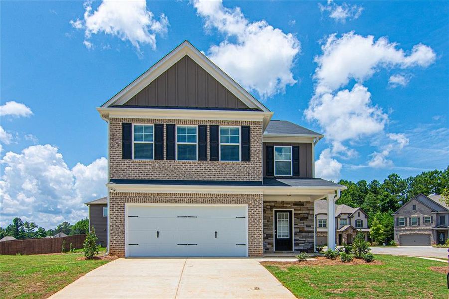 Front exterior of a new home in , Flowery Branch, GA, highlighting curb appeal (Image 1).