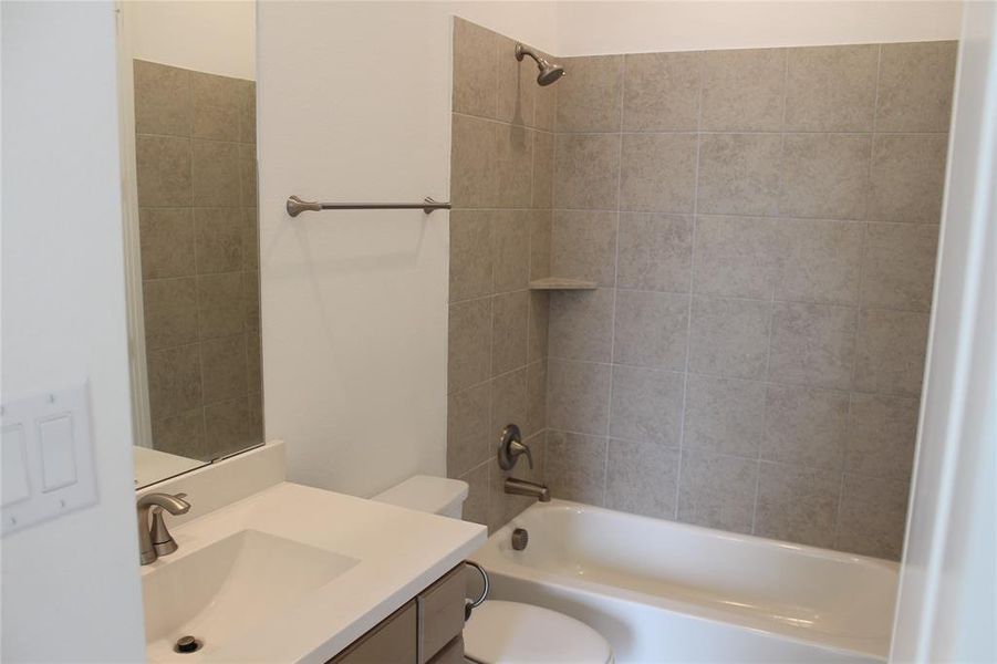 Upstairs ensuite bathroom featuring vanity and bathing tub / shower combination