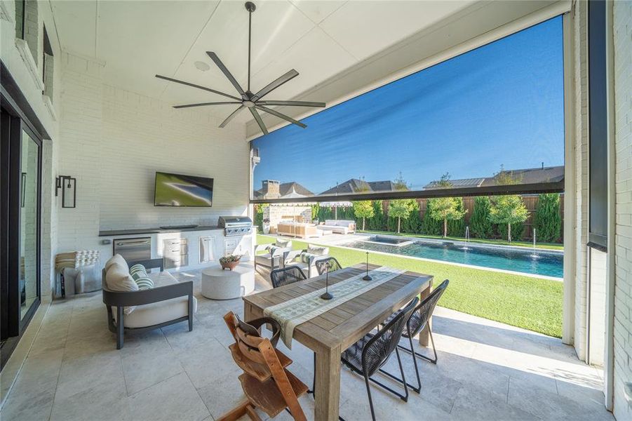 View of patio / terrace with pool water feature, an outdoor kitchen, and area for grilling