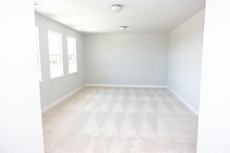 Empty room with light colored carpet Empty room with light colored carpet