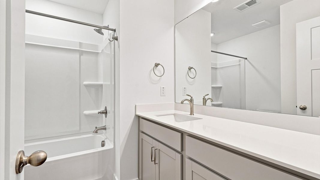 Top-notch bathroom with current fixtures, tasteful materials, and elevated charm at the Ransdell Pointe community