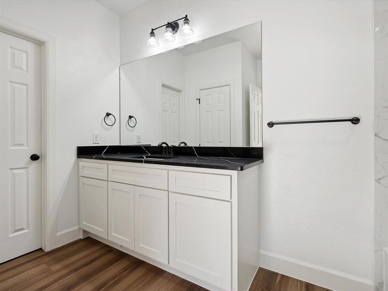 Bathroom with vanity and hardwood / wood-style flooring