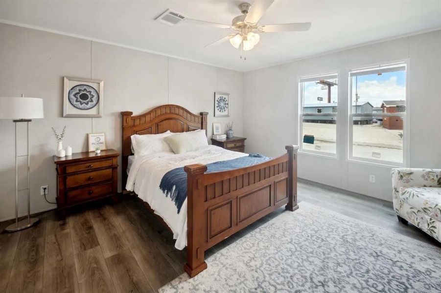 Bedroom featuring ceiling fan and dark hardwood / wood-style flooring