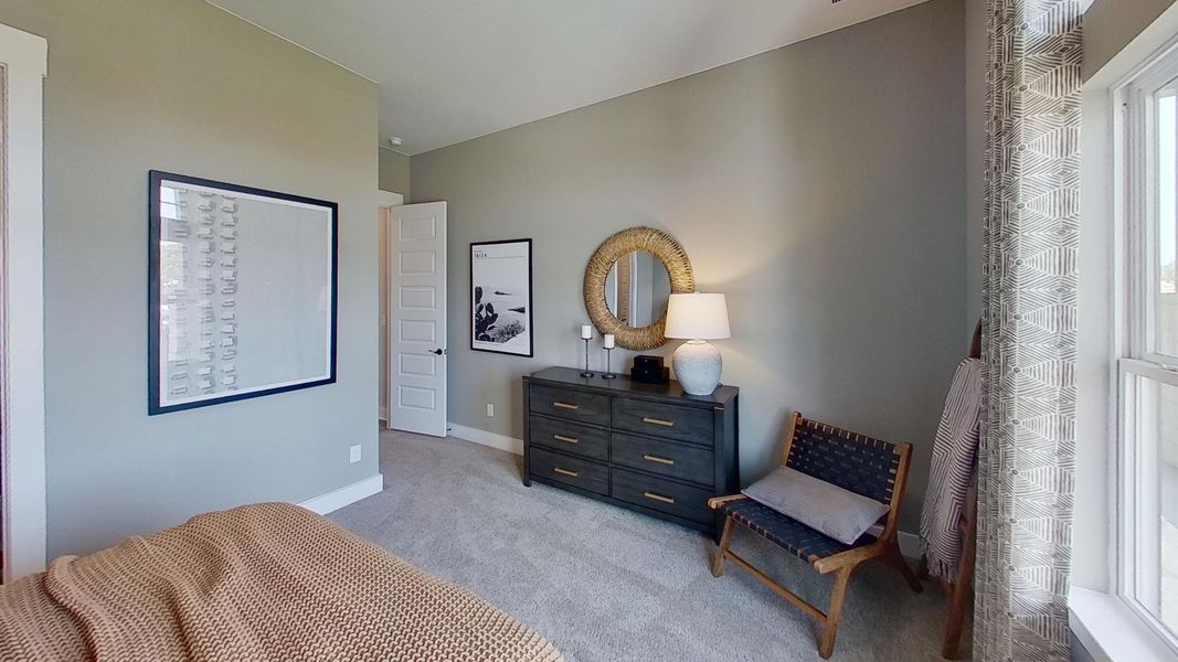 Bedroom with light carpet and baseboards