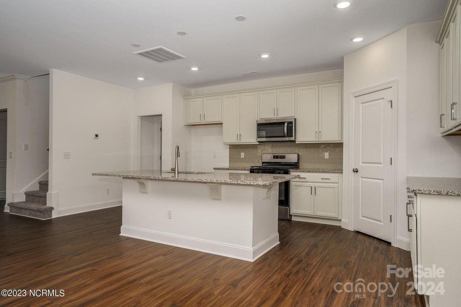 Concept photo of Upgraded Kitchen with granite counters, stainless steel appliances, large center island with seating, pantry, recessed lights & plenty of cabinets for storage!