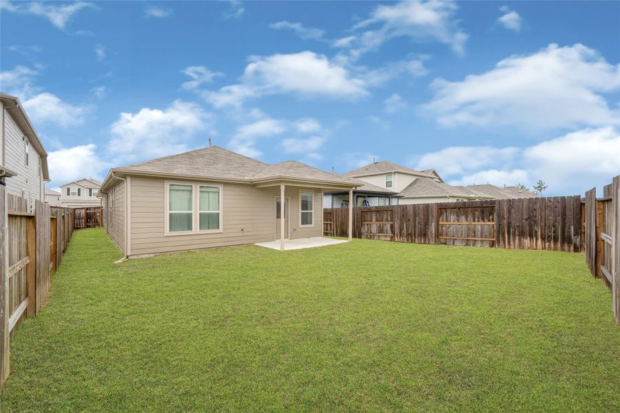 Another view of the expansive backyard, perfect for outdoor entertaining, gardening, or play.