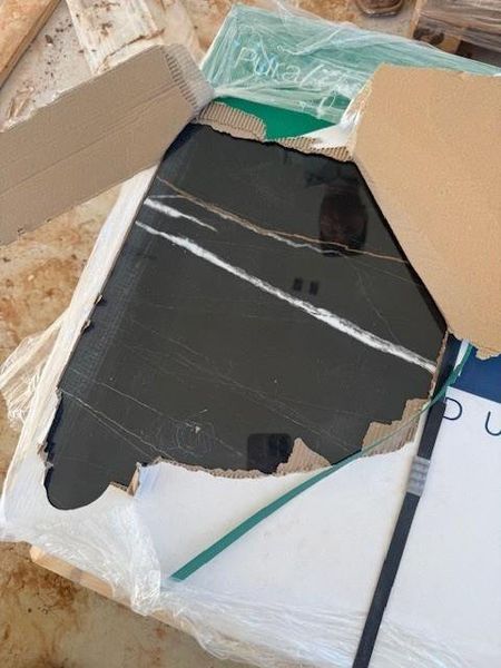 Upgraded bathroom tile with inflections of gold and white accents.